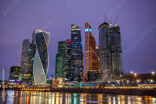Moscow City International Business Centre skyscraper buildings with panoramic windows night view. Moscow City at night. Lights are reflected in the river.