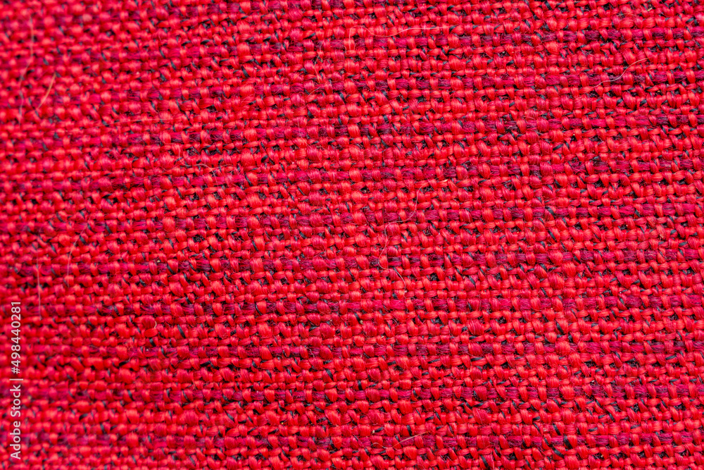 Texture of rough red synthetic fabric. Fabric for furniture and outdoor accessories. Cushion fabric. Texture of rough red synthetic fabric. Fabric for furniture and outdoor accessories. Cushion fabric.