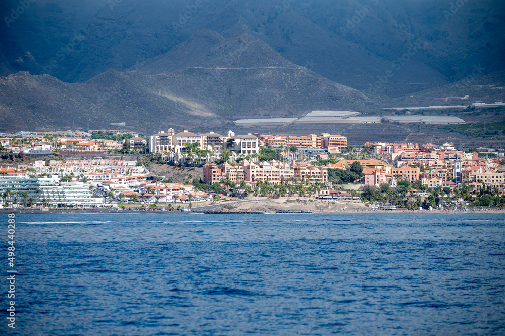 View on resorts and beaches of South coast of Tenerife island during sail boat trip along coastline, Canary islands, Spain