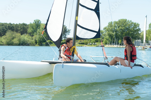 couple sailing on a lake during the summer © auremar