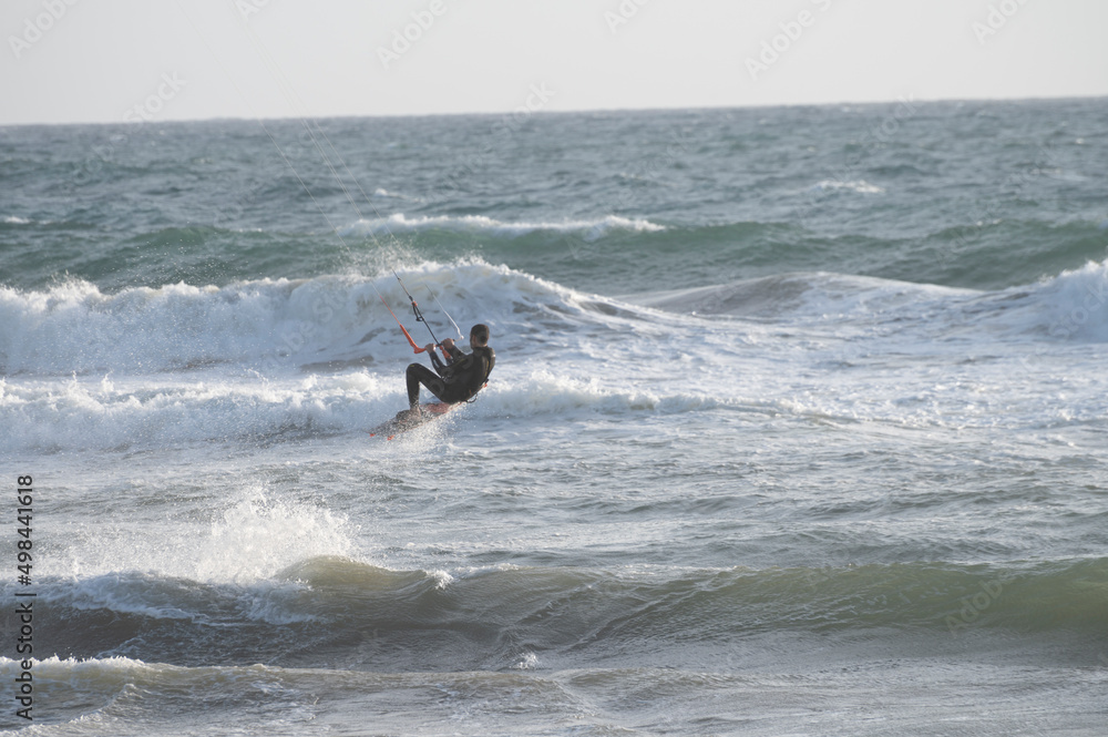 Water sport at cold winter water of Tyrrhenian sea between two touristic towns Sperlonga and Terracina in Lazio, Italy Water sport at cold winter water of Tyrrhenian sea between two touristic towns Sperlonga and Terracina in Lazio, Italy