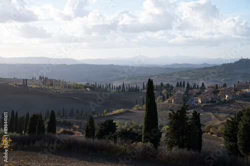 Panoramic view on hills near Pienza, Tuscany, Italy. Tuscan landscape with cypress trees, vineyards, forests and ploughed fields in autumn.