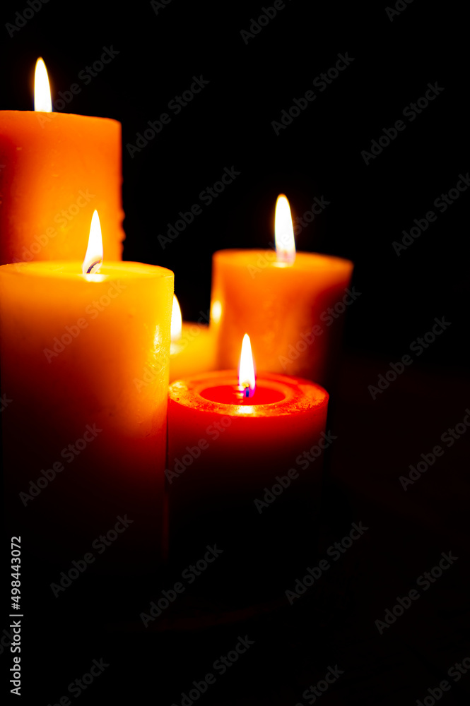 Burning red candles on black background Burning red candles on black background