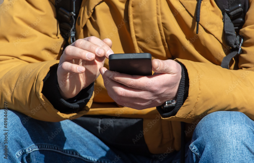 A man with a phone in his hands. A man with a phone in his hands.