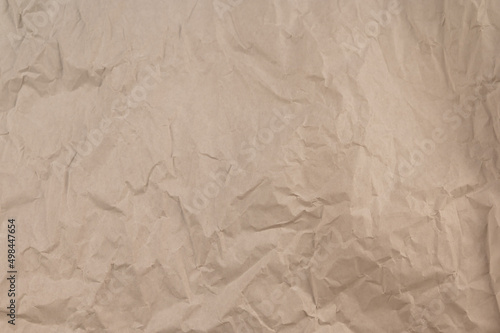 Beige abstract multitasking background. Crumpled bamag texture. Crumpled paper surface.