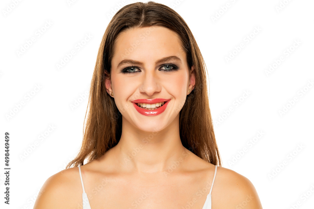Beautiful smiling woman with make up and long hair on a white background Beautiful smiling woman with make up and long hair on a white background