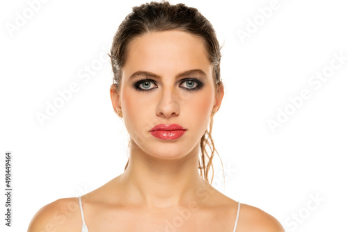 Beautiful serious woman with make up on a white background