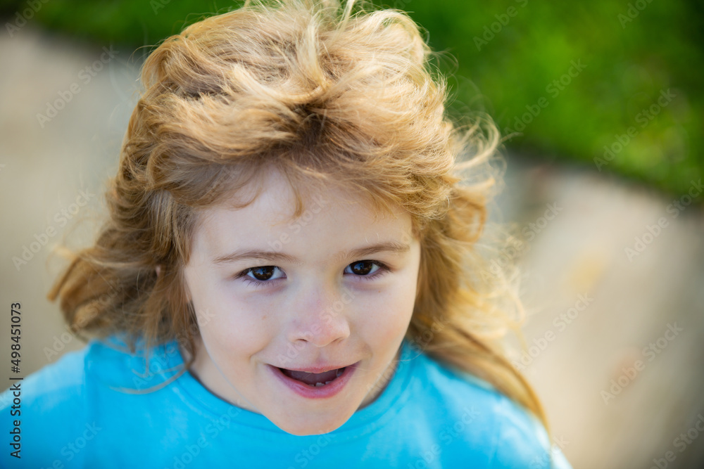 Adorable little girl boy closeup outdoors in summer. Kids face close up. Funny blonde little child close up portrait. Adorable little girl boy closeup outdoors in summer. Kids face close up. Funny blonde little child close up portrait.