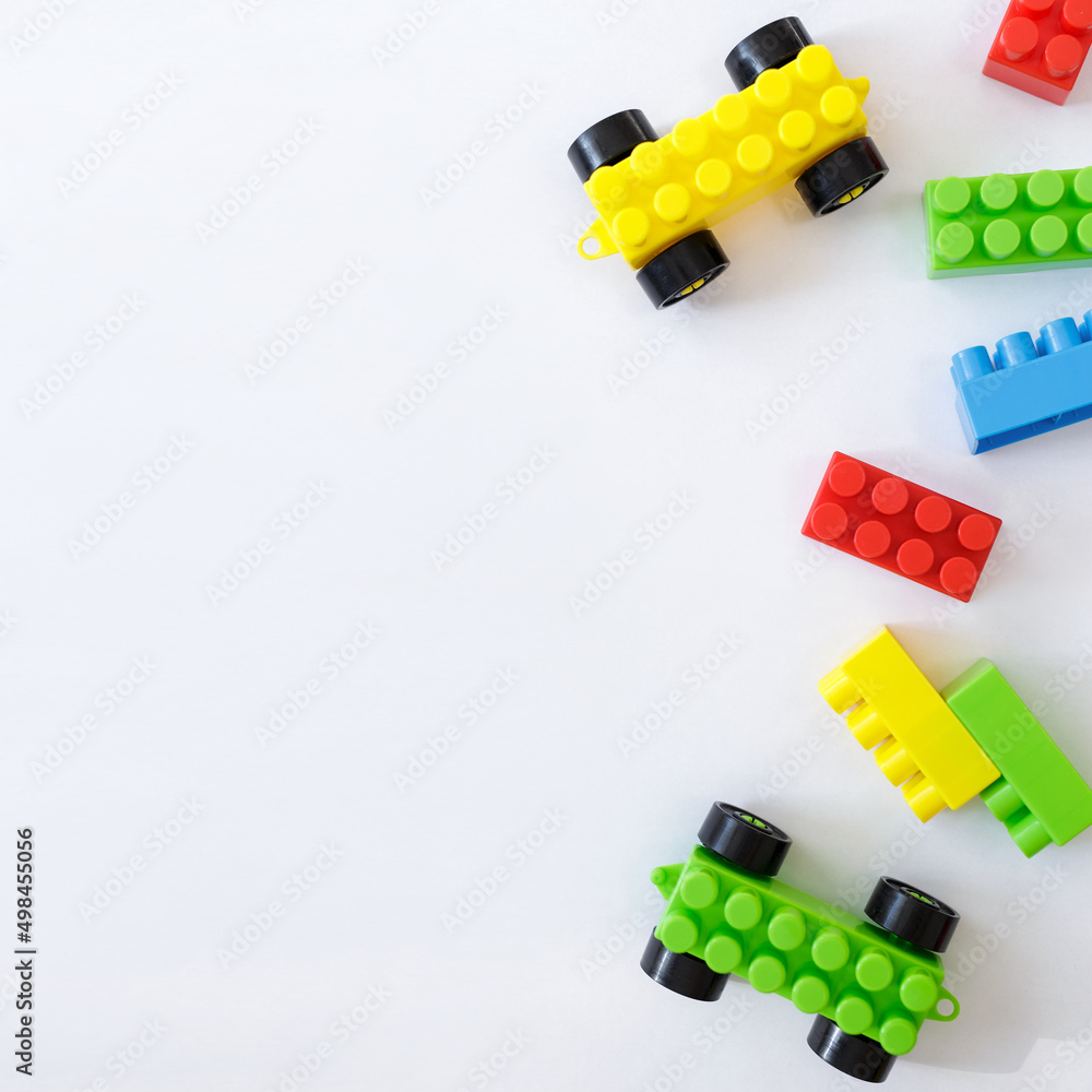 Obraz premium childhood and creativity concept - colorful toy constructor blocks over white background