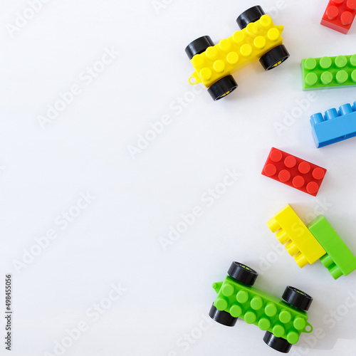 childhood and creativity concept - colorful toy constructor blocks over white background