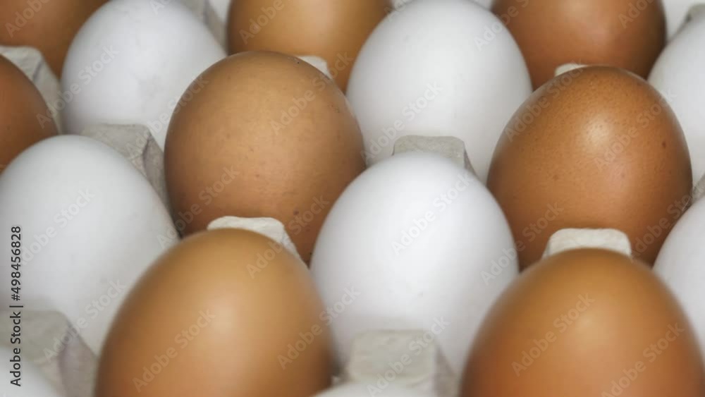 Chicken eggs rotates, top view. Raw eggs in the tray .Easter eggs background Chicken eggs rotates, top view. Raw eggs in the tray .Easter eggs background