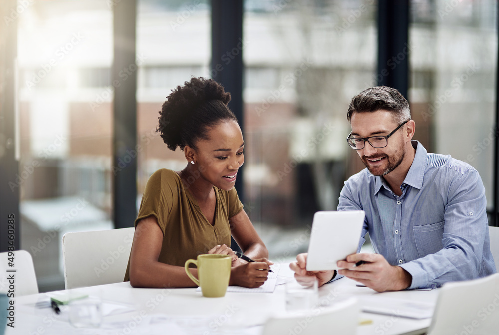 Staying updated with all the modern business trends. Cropped shot of businesspeople discussing something on a digital tablet. Staying updated with all the modern business trends. Cropped shot of businesspeople discussing something on a digital tablet.
