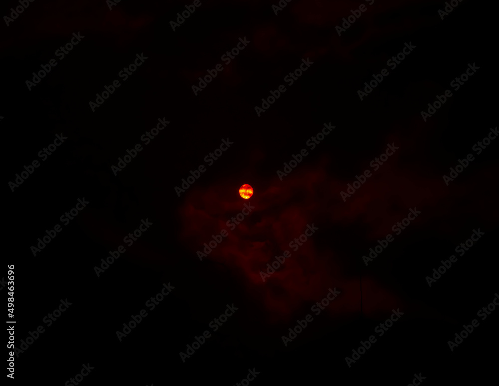The sun photographed in its natural beauty through a red filter on a black background The sun photographed in its natural beauty through a red filter on a black background