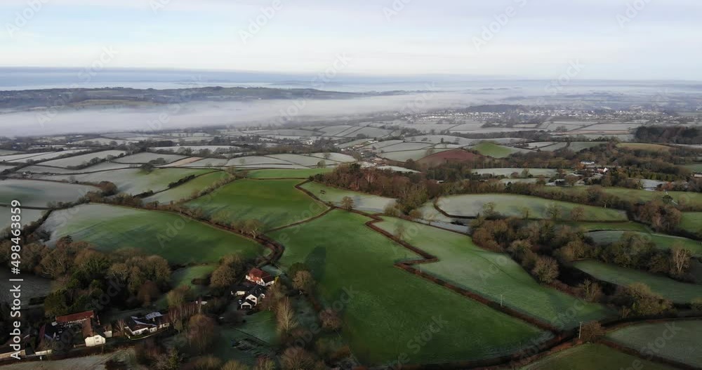 Aerial backwards shot of the Otter Valley countryside in Devon England on a frosty morning Aerial backwards shot of the Otter Valley countryside in Devon England on a frosty morning