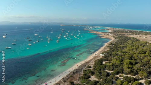 Drone video of Ses Illetes island in Formentera, surrounded by yatchs, Ibiza, Spain photo