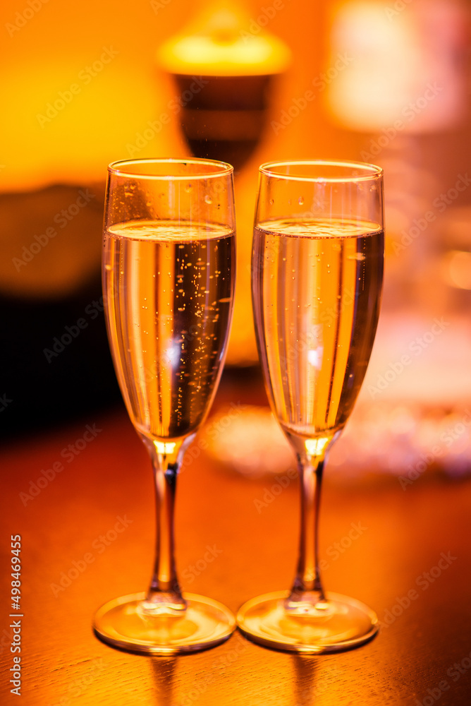 Two glasses of cold champagne. Warm shades. Two glasses of cold champagne. Warm shades.