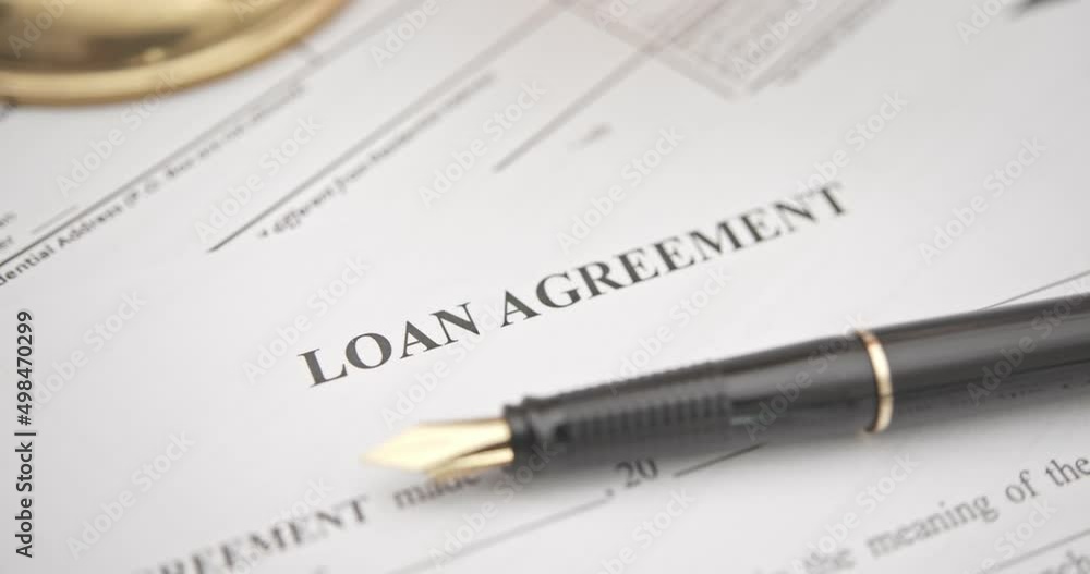 Business loan agreement or legal document concept : Fountain pen on a loan agreement paper form. Loan agreement is a contract between a borrower and a lender, a compilation of various mutual promises. Business loan agreement or legal document concept : Fountain pen on a loan agreement paper form. Loan agreement is a contract between a borrower and a lender, a compilation of various mutual promises.