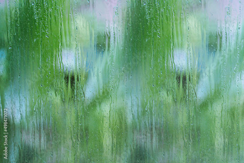 Blue and green background. Glass with natural water drops. 