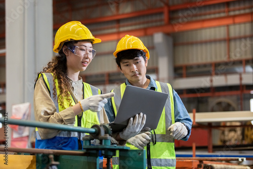 engineer male and female using laptop working in manufacturing factory. teamwork technician metalwork automated mechanic energy project.