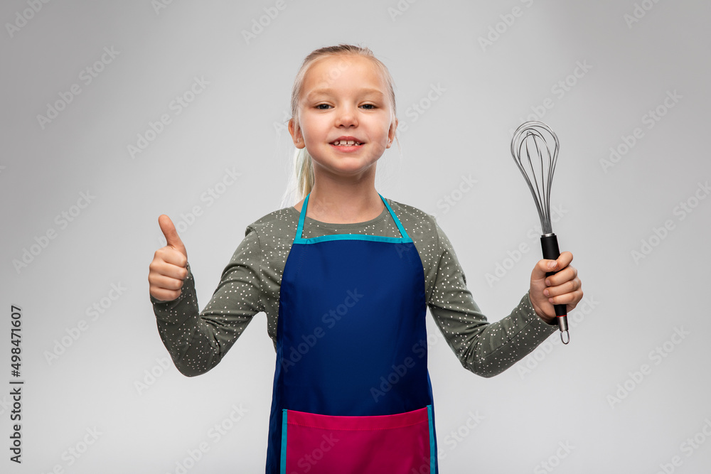 cooking, culinary and profession concept - happy smiling little girl in apron holding whisk showing thumbs up over grey background cooking, culinary and profession concept - happy smiling little girl in apron holding whisk showing thumbs up over grey background