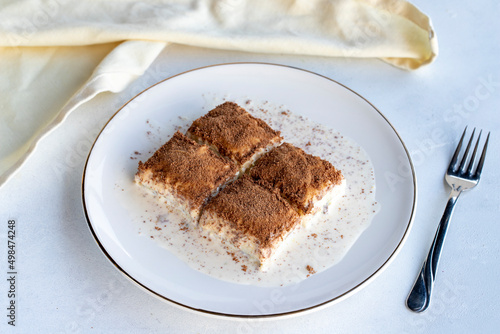 Cold baklava on a white background. Baklava with pistachio milk. Traditional Turkish cuisine delicacies. The new trend is baklava. close-up. local name soguk baklava photo