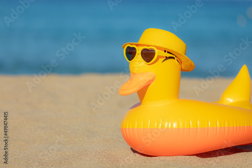 Yellow duck against blue sea and sky background