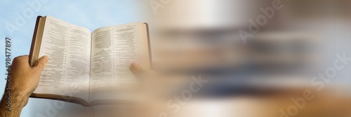 Close up view of hand holding a holy bible with copy space