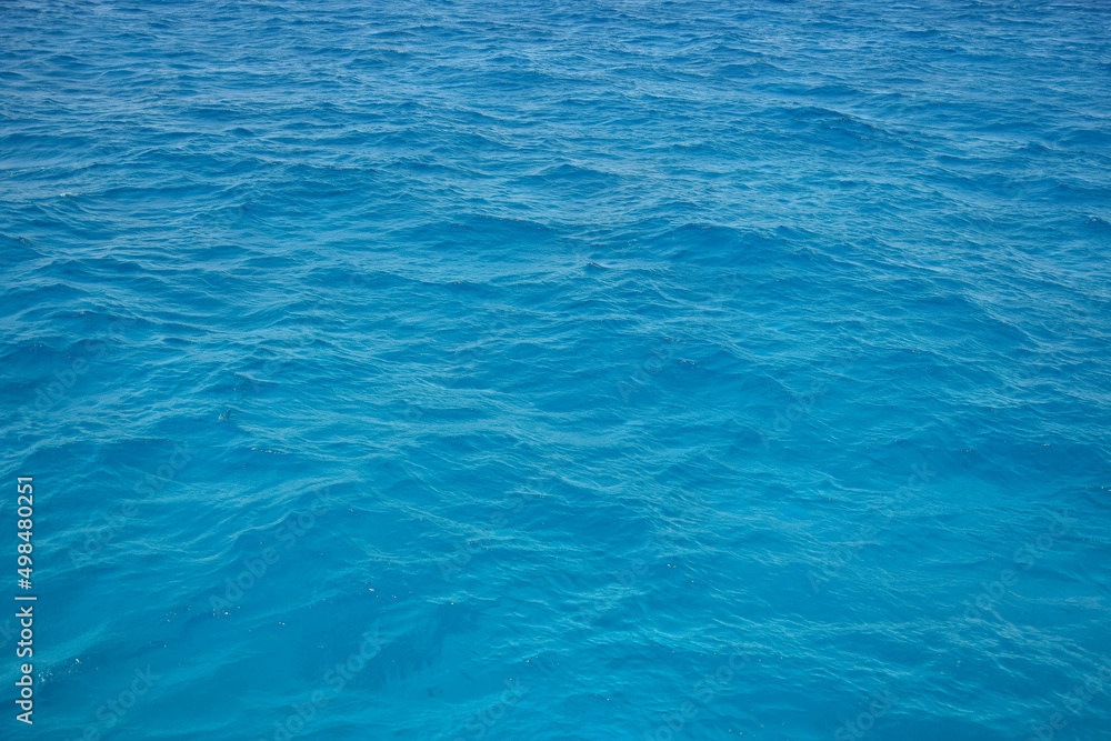 Waves of blue sea water. Abstract background. Copy space. Selective focus.