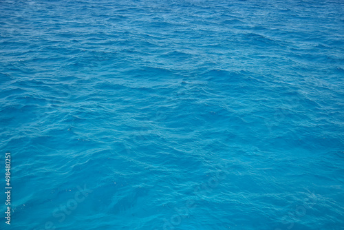 Waves of blue sea water. Abstract background. Copy space. Selective focus.