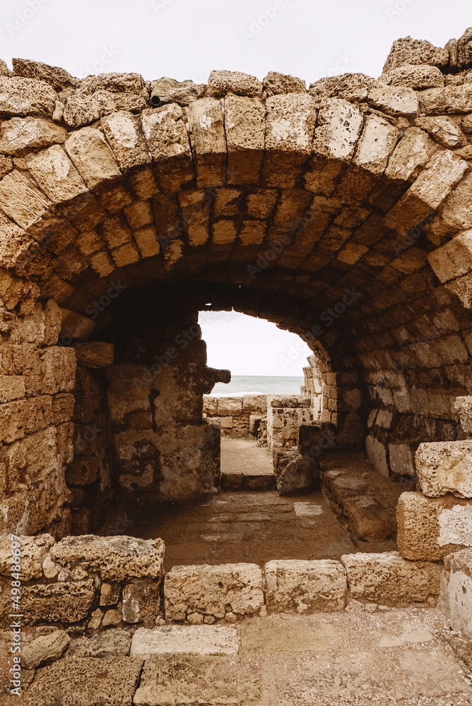 An ancient arch made of stone bricks. Caesarea. Israel