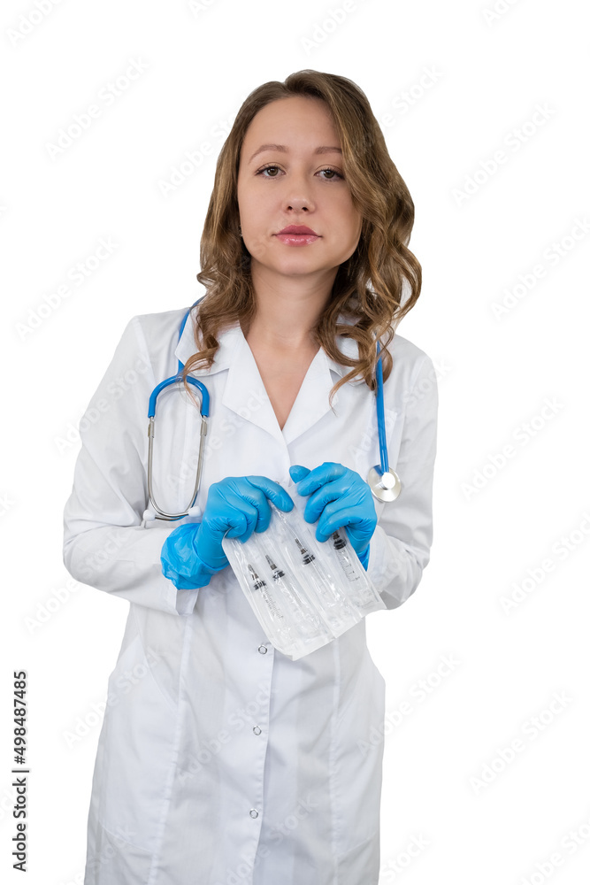 Portrait of a doctor in a bathrobe with a stethoscope. The girl holds a medical syringe in her hands. Portrait of a doctor in a bathrobe with a stethoscope. The girl holds a medical syringe in her hands.