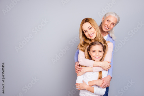 Photo of three cheerful friendly woman cuddle toothy smile isolated on grey color background