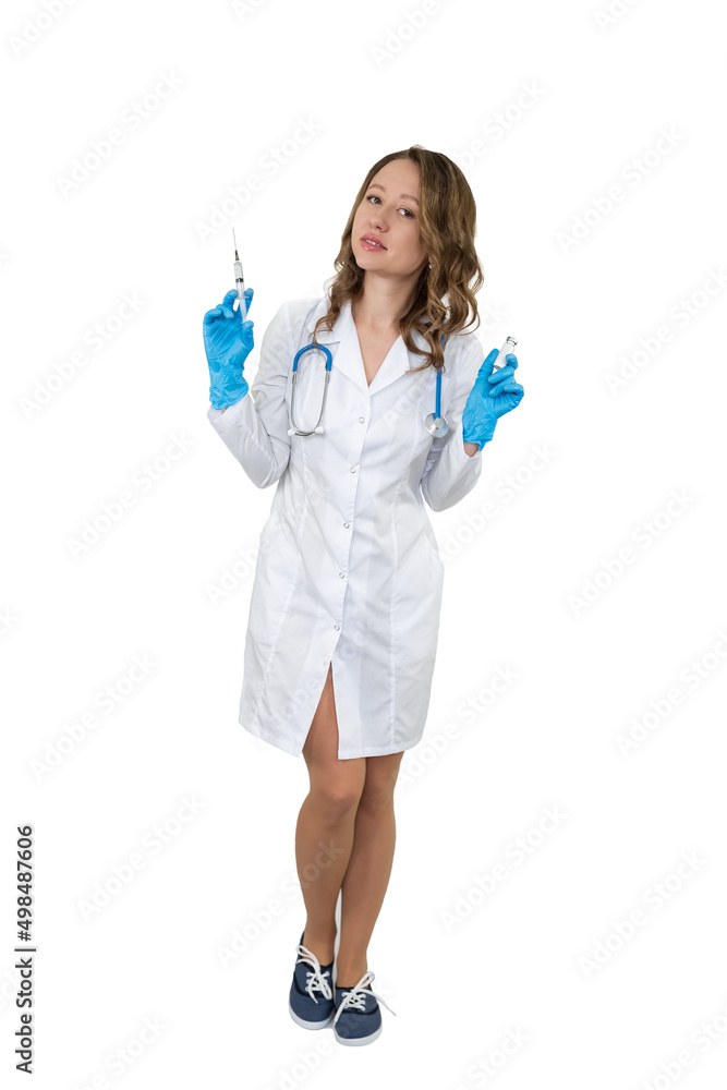 Portrait of a doctor in a bathrobe with a stethoscope. The girl holds a medical syringe in her hands. Portrait of a doctor in a bathrobe with a stethoscope. The girl holds a medical syringe in her hands.