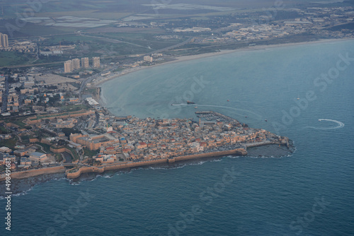 Aerial Panoramic view from privat aircraft of showing summer sunset view of Acco, Acre, Akko medieval old city with green roof Al Jazzar mosque and crusader palace, city walls, arab market