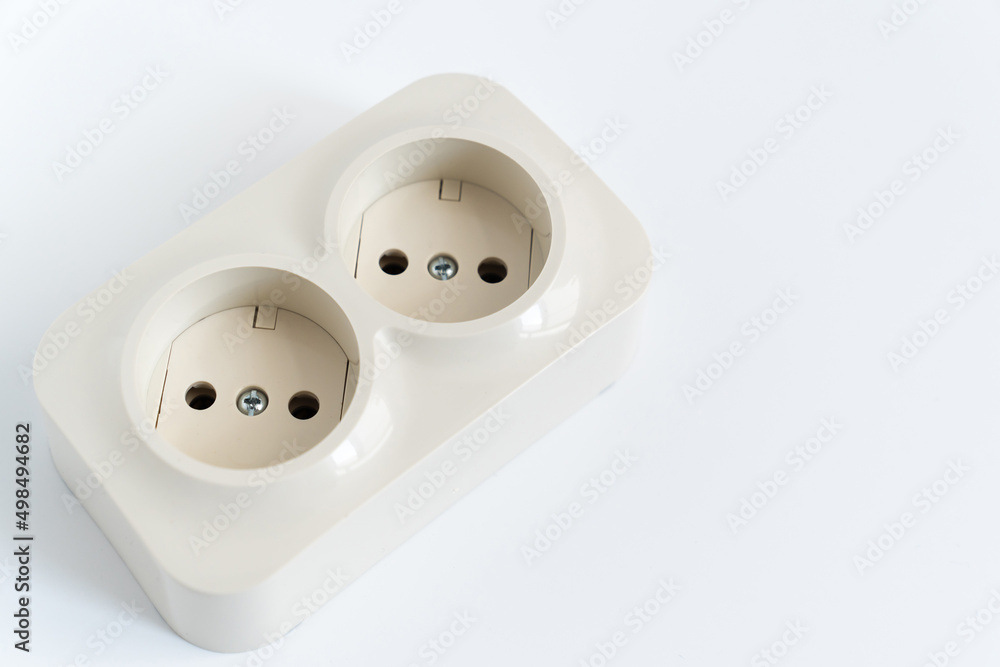 Double socket on a white background. two sockets, united by one monolithic case. The socket has two plug connectors, but is installed in one standard socket. electrical goods store. Double socket on a white background. two sockets, united by one monolithic case. The socket has two plug connectors, but is installed in one standard socket. electrical goods store.