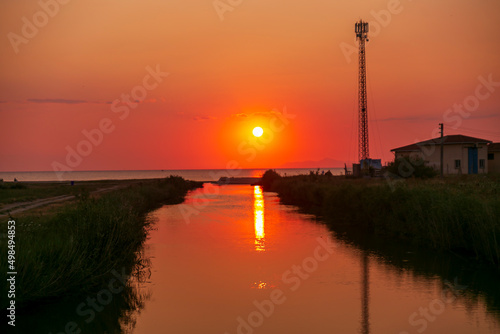  sunset by the sea, golden hour. amazing sunny side up sun. 