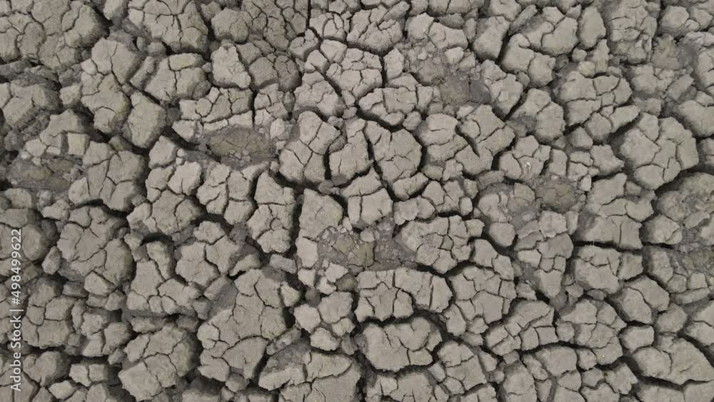 Cracked soil ground of dried lake or river. Aerial drone view of land destroyed by erosion and global warming. Ecological problem, drought, climate change, global warming concept. Environmental crisis Cracked soil ground of dried lake or river. Aerial drone view of land destroyed by erosion and global warming. Ecological problem, drought, climate change, global warming concept. Environmental crisis