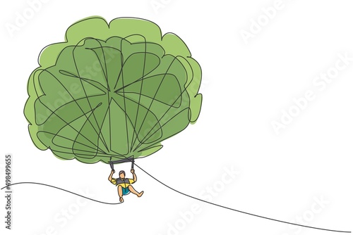 Single continuous line drawing of young tourist man flying with parasailing parachute on sky pulled by a boat. Extreme vacation holiday sport concept. Trendy one line draw design vector illustration photo
