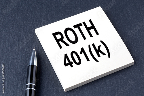 ROTH 401K text on the sticker with pen on the black background photo