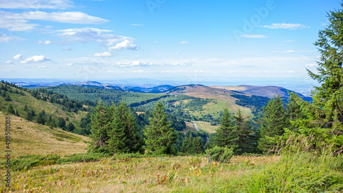 Visually Attractive View of Summer Countryside Mountain Nature Landscape. Picturesque Scenery Green Hills And Fields With Pine Trees. Beautiful Blue Sky With Clouds. Mountain Kopaonik, Serbia, Europe.