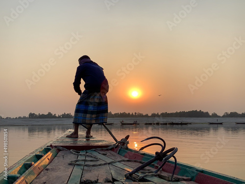 Boat Worker Boutha on jamuna river in Bangladesh - Sun kissing & Working photo