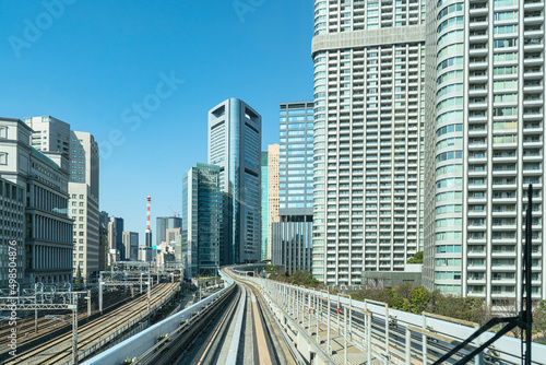Railways of Japan. Road infrastructure in Tokyo. Railway track near skyscrapers. Tokyo transport network. Railway between Tokyo and Odaiba. Overpass for high-speed trains. 