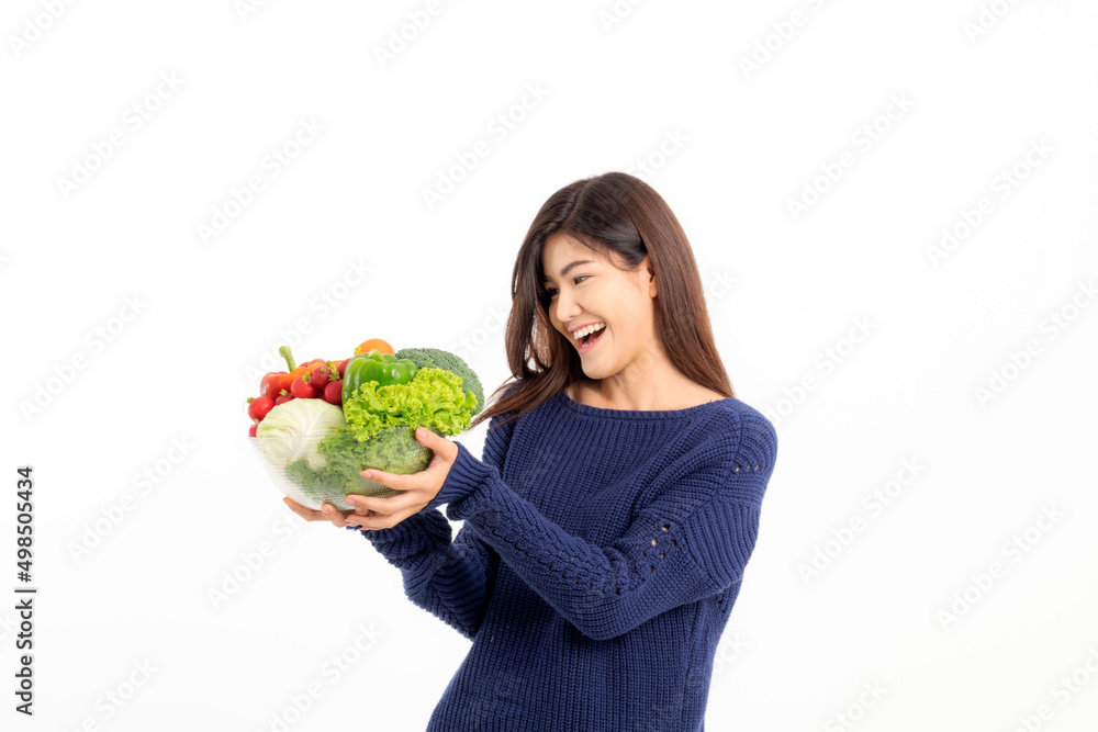 Portrait of a beautiful woman with long hair wearing a blue long-sleeve shirt holding vegetables on a white background. Selective focus. Portrait of a beautiful woman with long hair wearing a blue long-sleeve shirt holding vegetables on a white background. Selective focus.