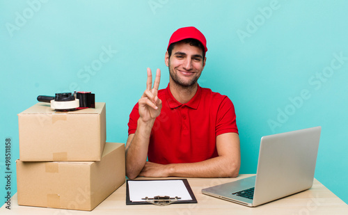 hispanic handsome man smiling and looking friendly, showing number two. packer employee concept photo