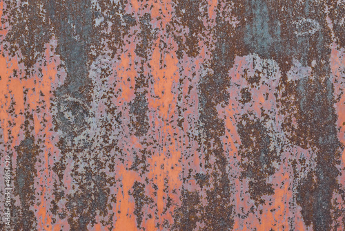 Rusting metal surface. Texture of worn and rusty metal surface with remains of several layers of red paint, high resolution.