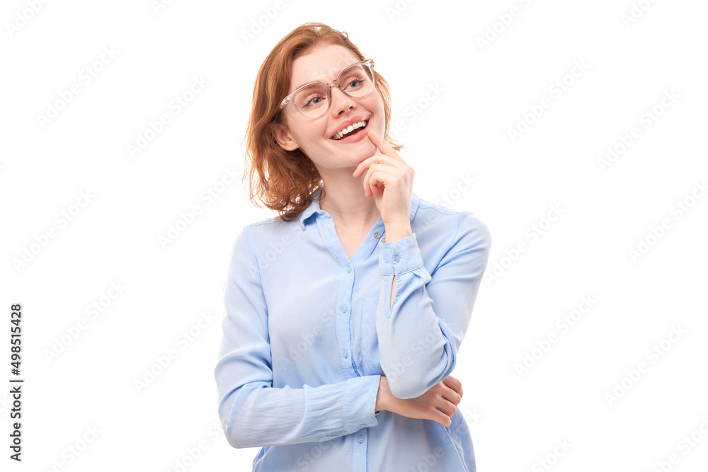 Smart redhead girl in glasses and business shirt holding chin thinks doubts, makes decision isolated on white studio background Smart redhead girl in glasses and business shirt holding chin thinks doubts, makes decision isolated on white studio background