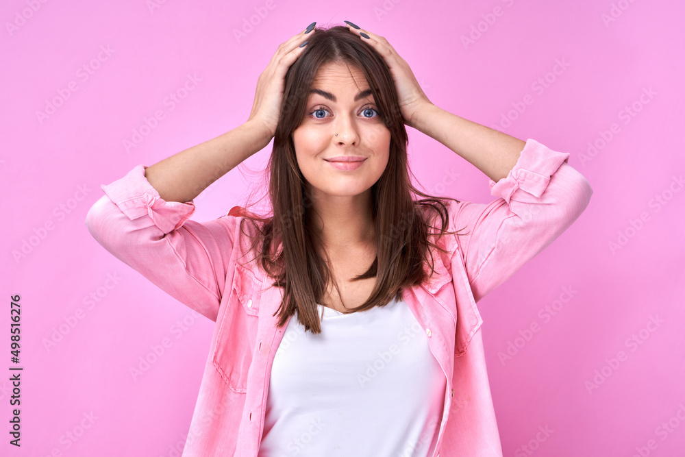 Smart brunette girl in casual holding her head thinks doubts, makes decision isolated on pink studio background Smart brunette girl in casual holding her head thinks doubts, makes decision isolated on pink studio background