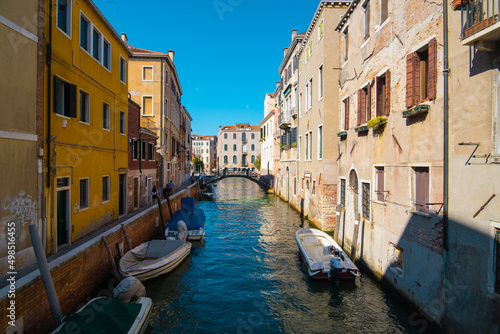 VENICE, ITALY - August 27, 2021: View of empty water streets with a few tourists on the canals of Venice.