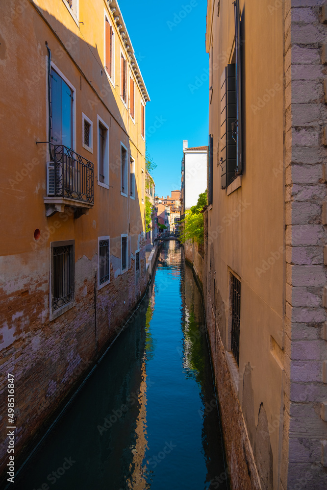 View of an extremely narrow and empty canal in Venice, Italy