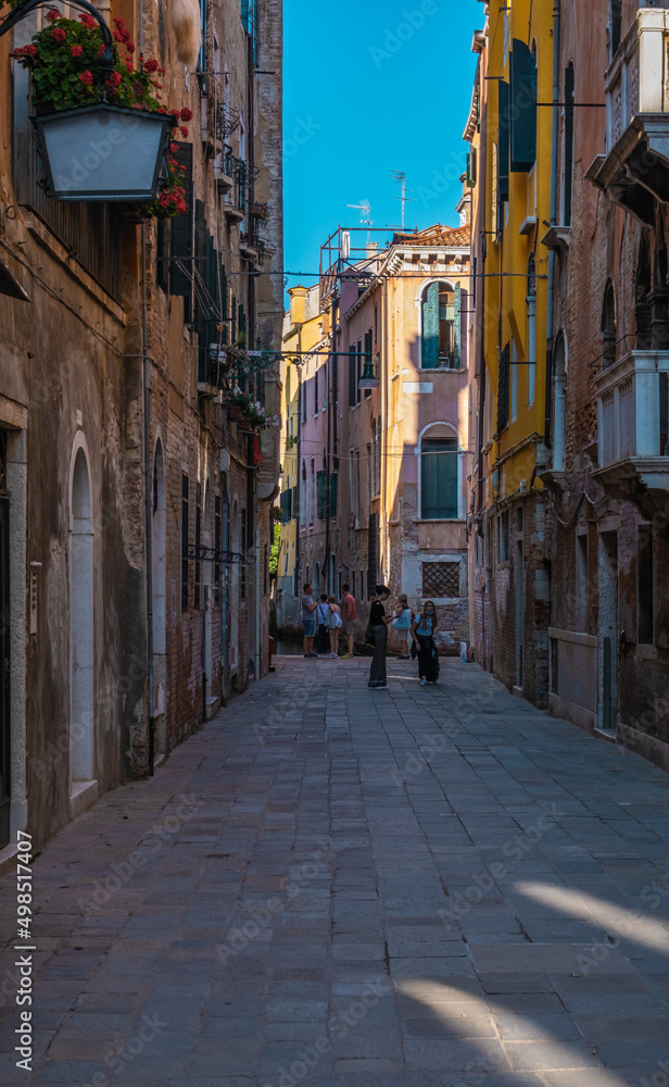 VENICE, ITALY - August 27, 2021: People walking by over Venice streets during the pandemic